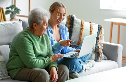 showing laptop to elder | hoa service requests