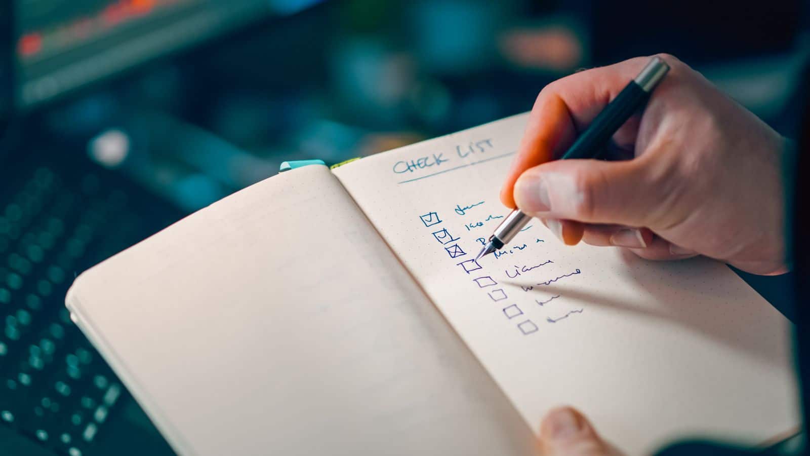 Hand completing a checklist for HOA projects and action items